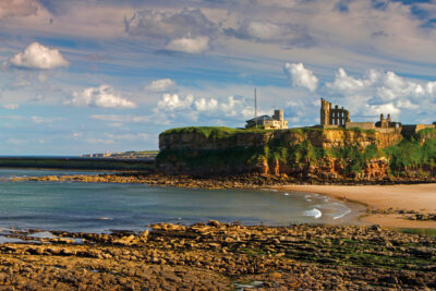 A panoramic view in the evening of Tynemouth Castle and Priory as seen from King Edwards Bay looking south towards South Shields