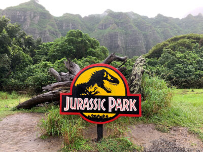 Jurassic Park sign in front of fallen tree at Kualoa Ranch in Hawai'i