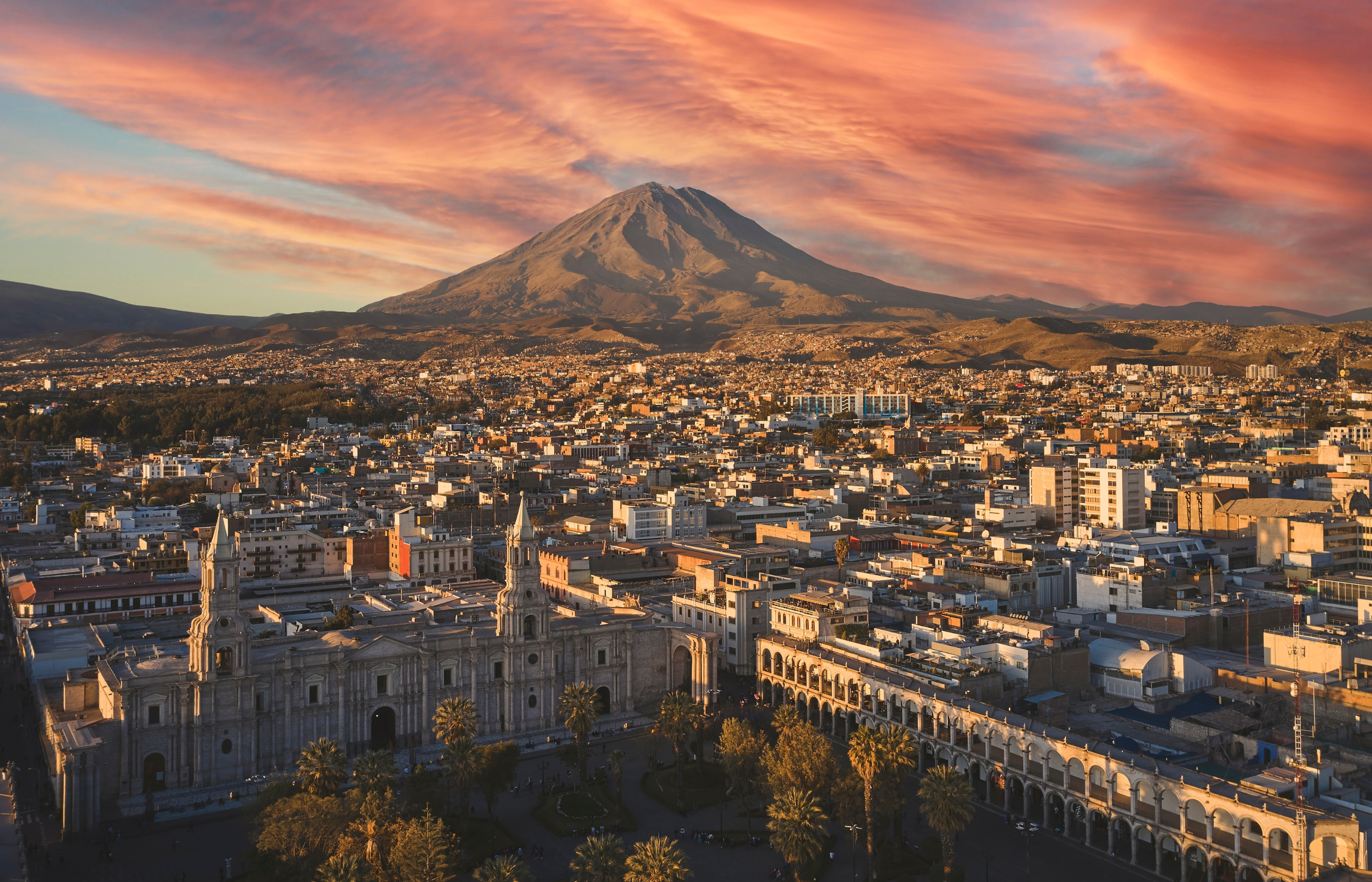 Aerial drone view of Arequipa main square and cathedral church, with the Misti volcano at sunset. Arequipa, Peru